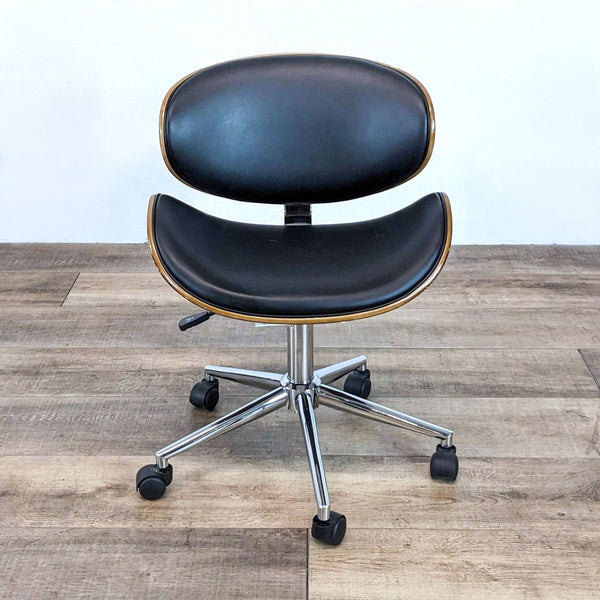 Curved wood task chair with faux leather cushions and chrome base.