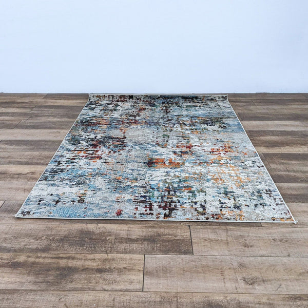 Madison Blue Gray rug with multicolor design on wooden floor.