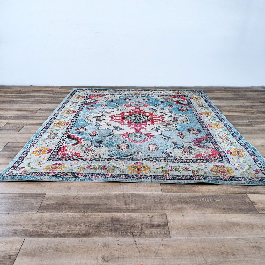 Rug on wooden floor showcasing floral motifs and vibrant colors.