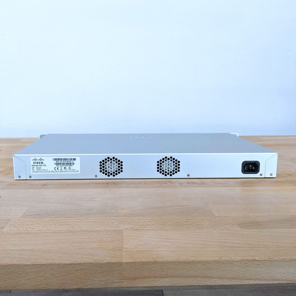 1. Rear view of a Cisco & Bros. networking equipment showing cooling vents, power input, and product label.