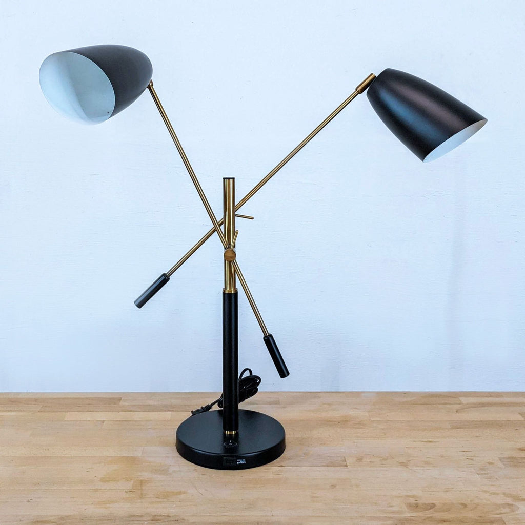 2. Modern black and gold dual-shade lamp by Zuo Modern, featuring adjustable cone shades on a wooden surface.