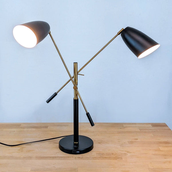 1. Retro-inspired Zuo Modern steel lamp with twin adjustable black and gold cone shades, both illuminated.