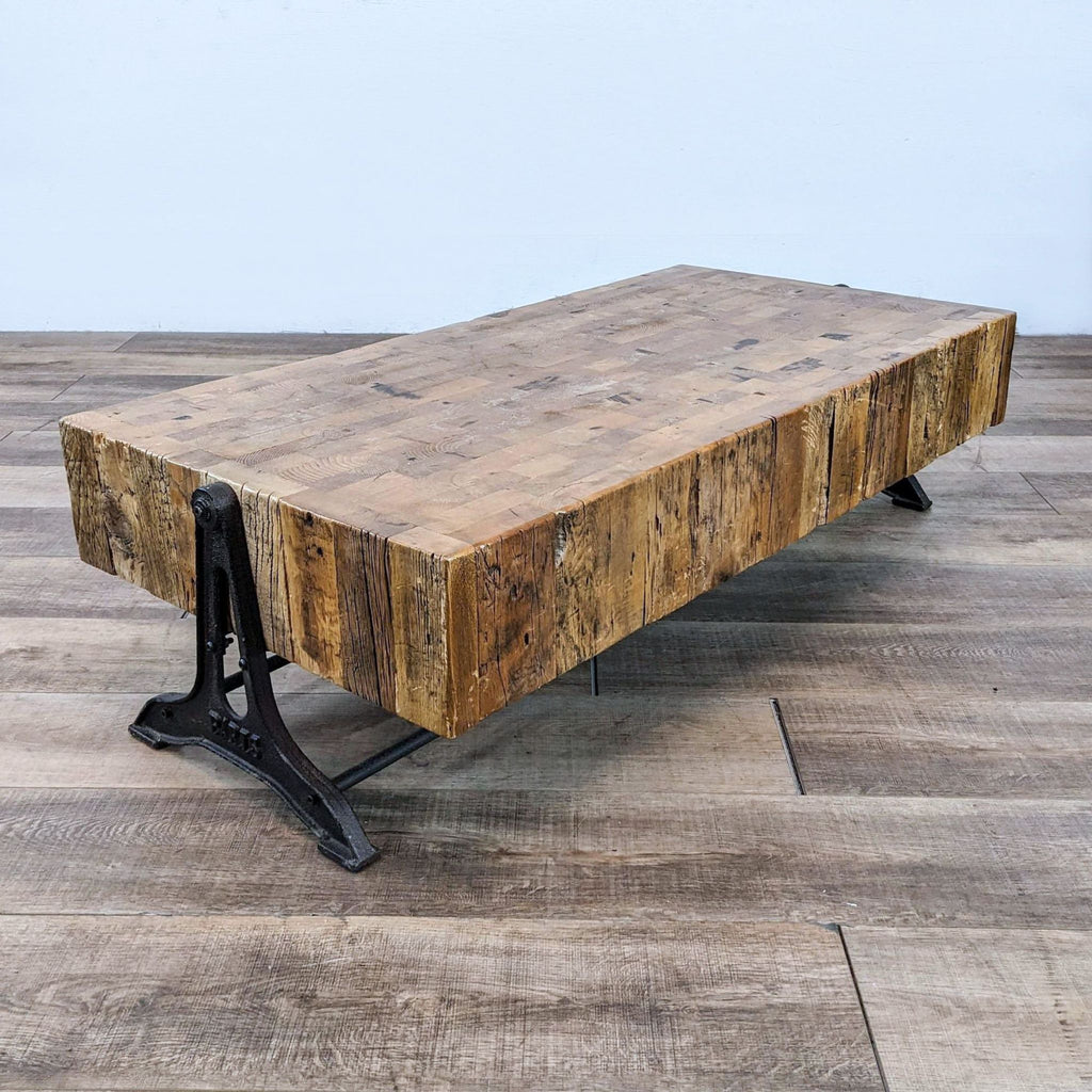 Low coffee table featuring a large wooden slab top with a sturdy iron base.