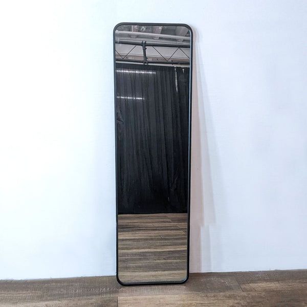 Sleek over-the-door mirror with rounded edges and metal frame, adds modern style and space.