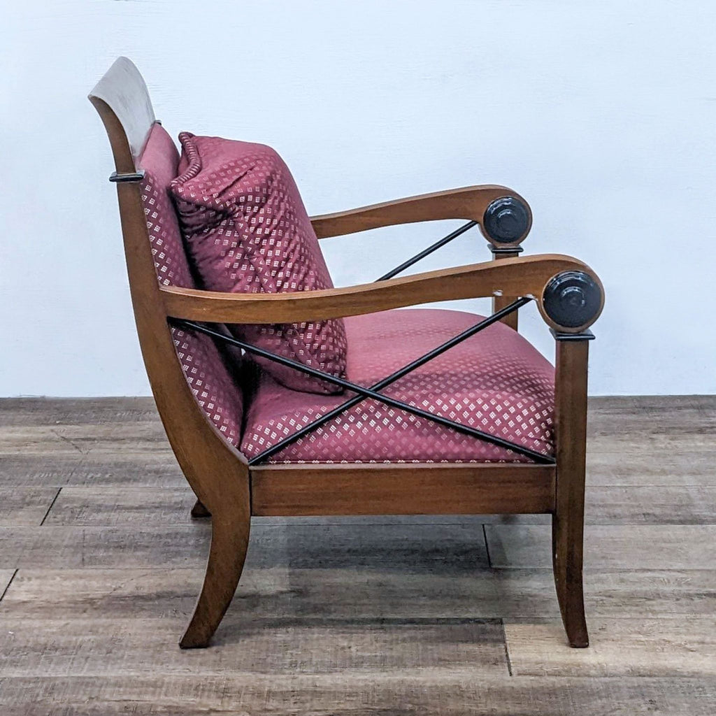 Side view of Reperch armchair showing wood frame, red upholstery, and X detailing.