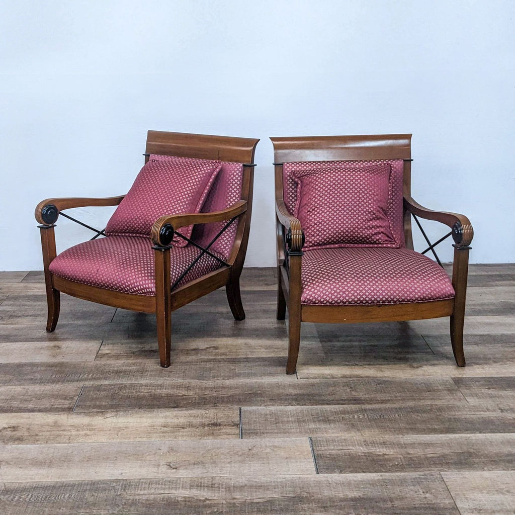 Pair of Reperch armchairs with wood frame, upholstered red seats, and X detailing.