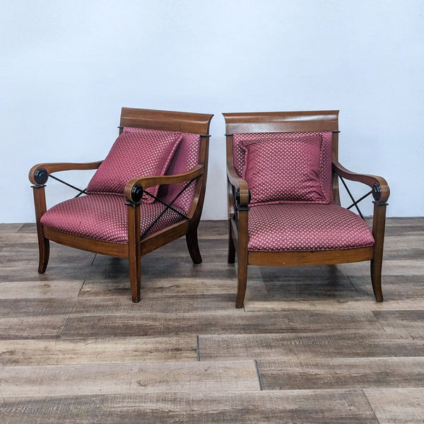 Pair of Reperch armchairs with wood frame, upholstered red seats, and X detailing.