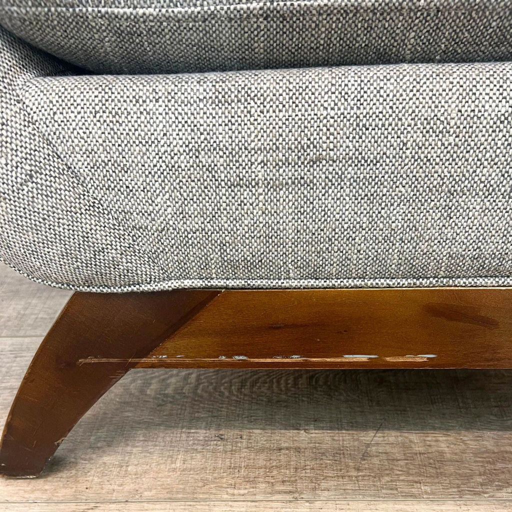 Close-up of Jasper chair's textured fabric and wood base.