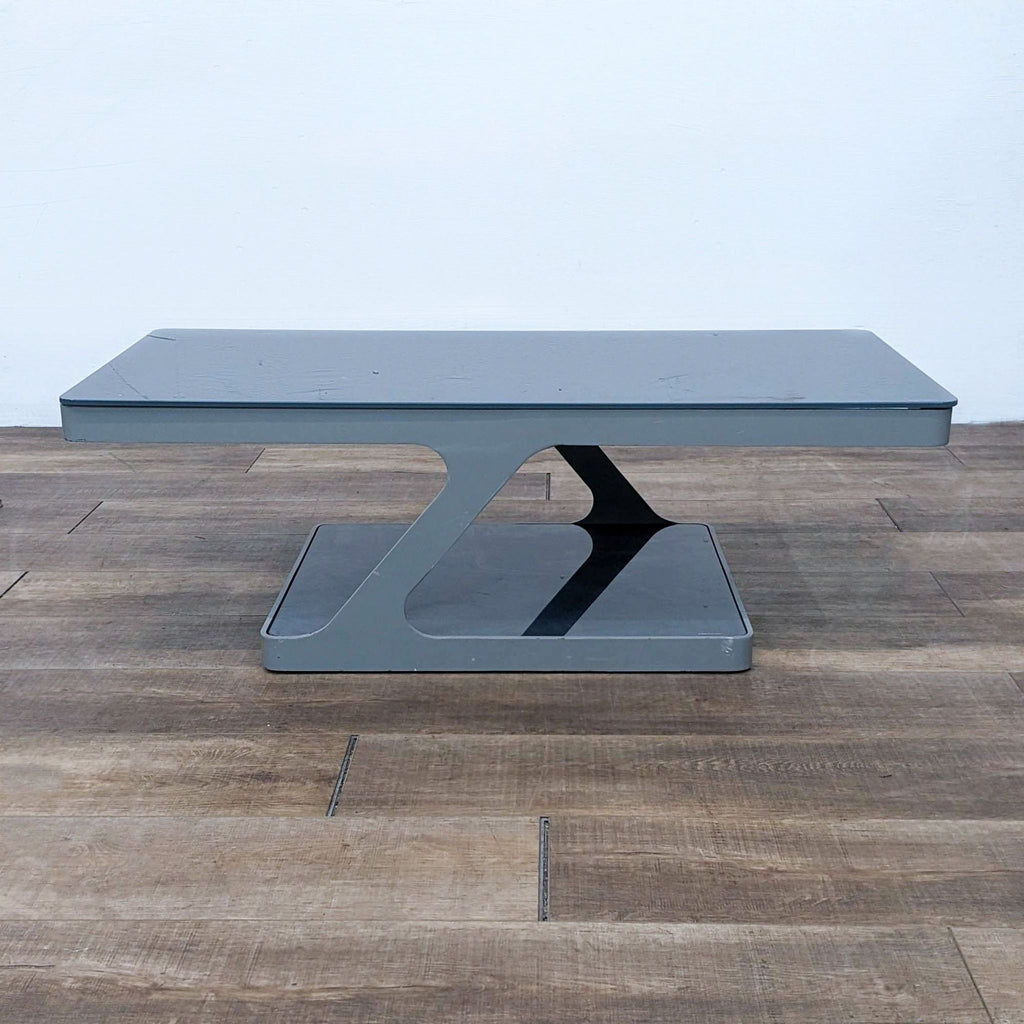 Reperch coffee table with smokey glass top and modern design.