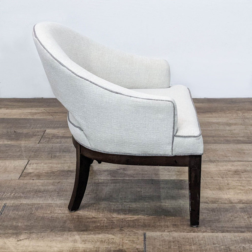 Side view of the French-inspired Crystal chair, featuring curved legs and open back design by Madison Park.