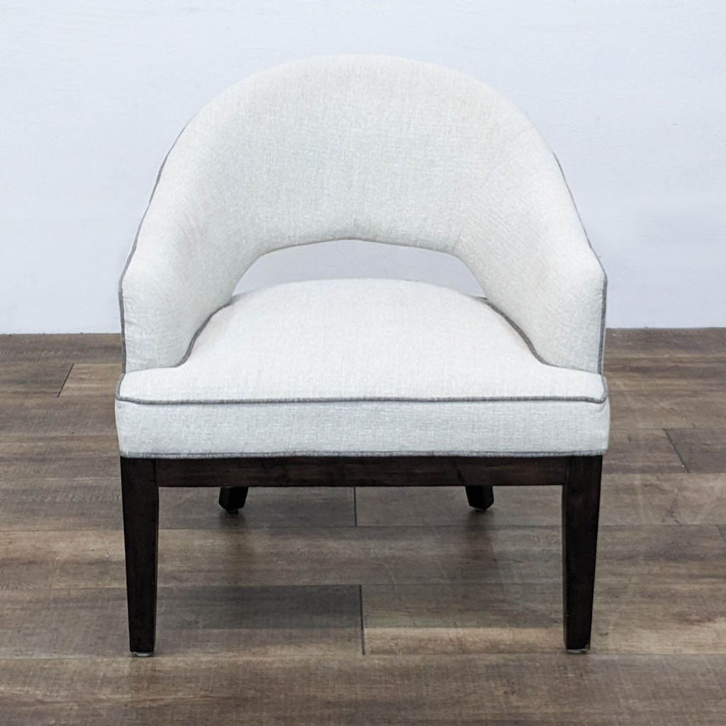 Front view of the Crystal chair with cream linen upholstery and curved saber legs by Madison Park.