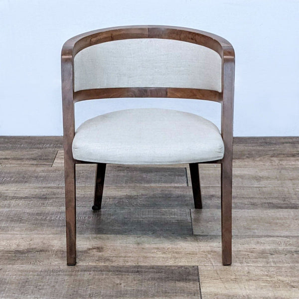 Front view of a mid-century modern chair with wood frame and linen upholstery.