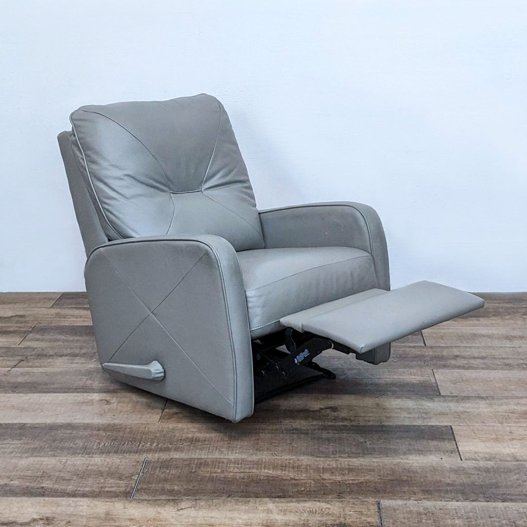 Side view of the recliner with footrest extended and visible handle on the side.