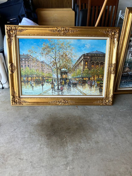 1. Framed oil painting of a busy Paris street with people, trees, and historic buildings, in a gold ornate frame.