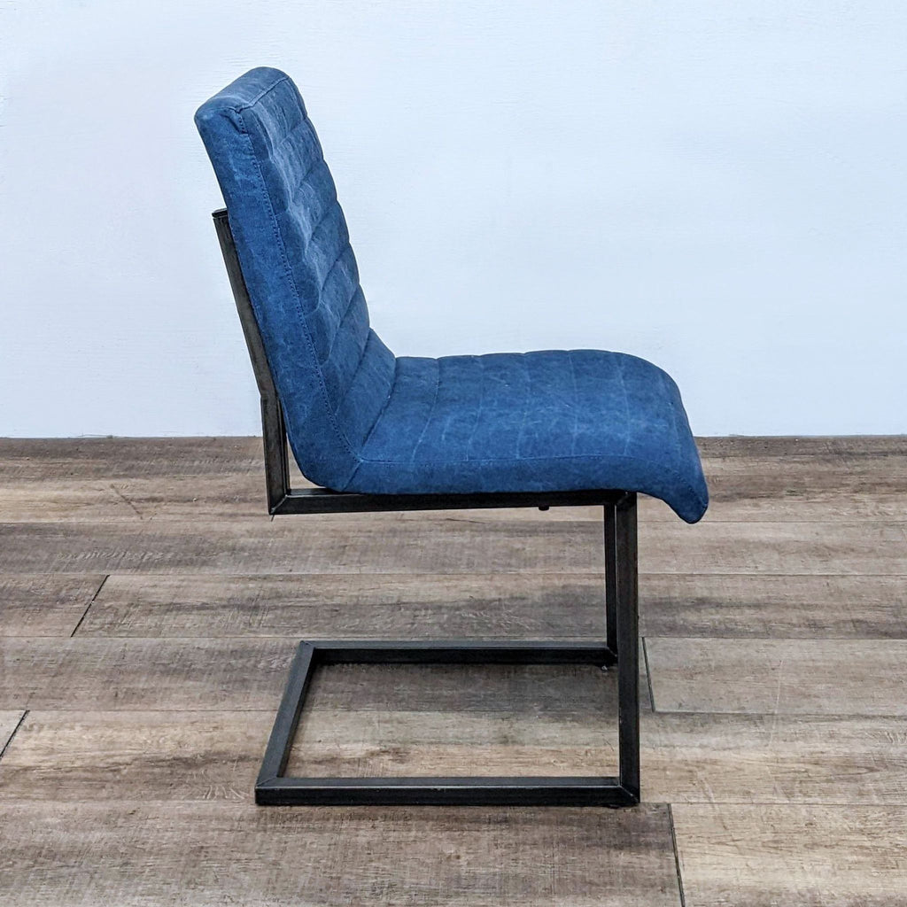 Sleek dining chair by Moe’s Home Collection, with blue fabric and metal base, side view.