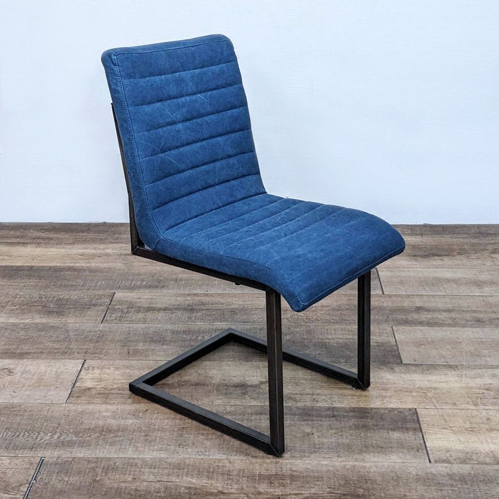 Contemporary dining chair with metal legs and tufted blue cushioning from Moe’s Home Collection.