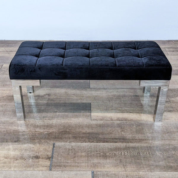 Modern tufted bench in black velvet with a chrome frame, perfect for stylish seating.