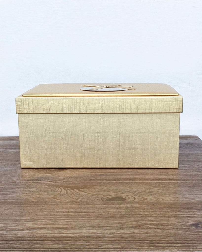 Closed gold box containing Royal Sealy cutlery set.