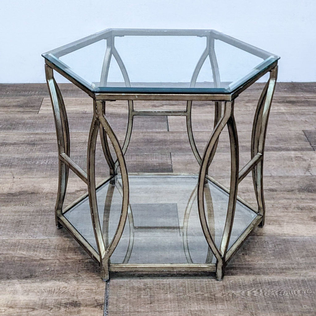 1. Hexagonal glass end table by Z Gallerie with metallic gold frame and modern openwork design, shown on wood floor.