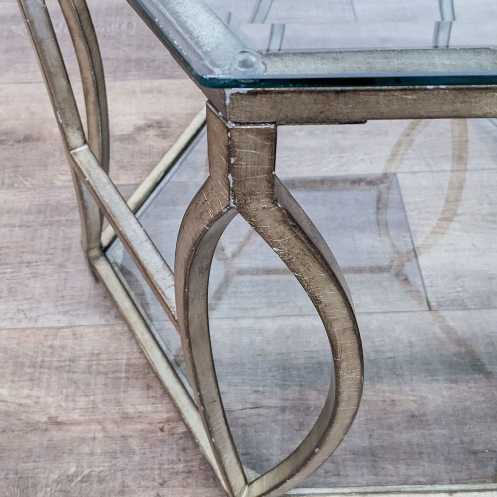 3. Close-up of corner detail on Z Gallerie end table, highlighting glass top and distressed gold metal frame.