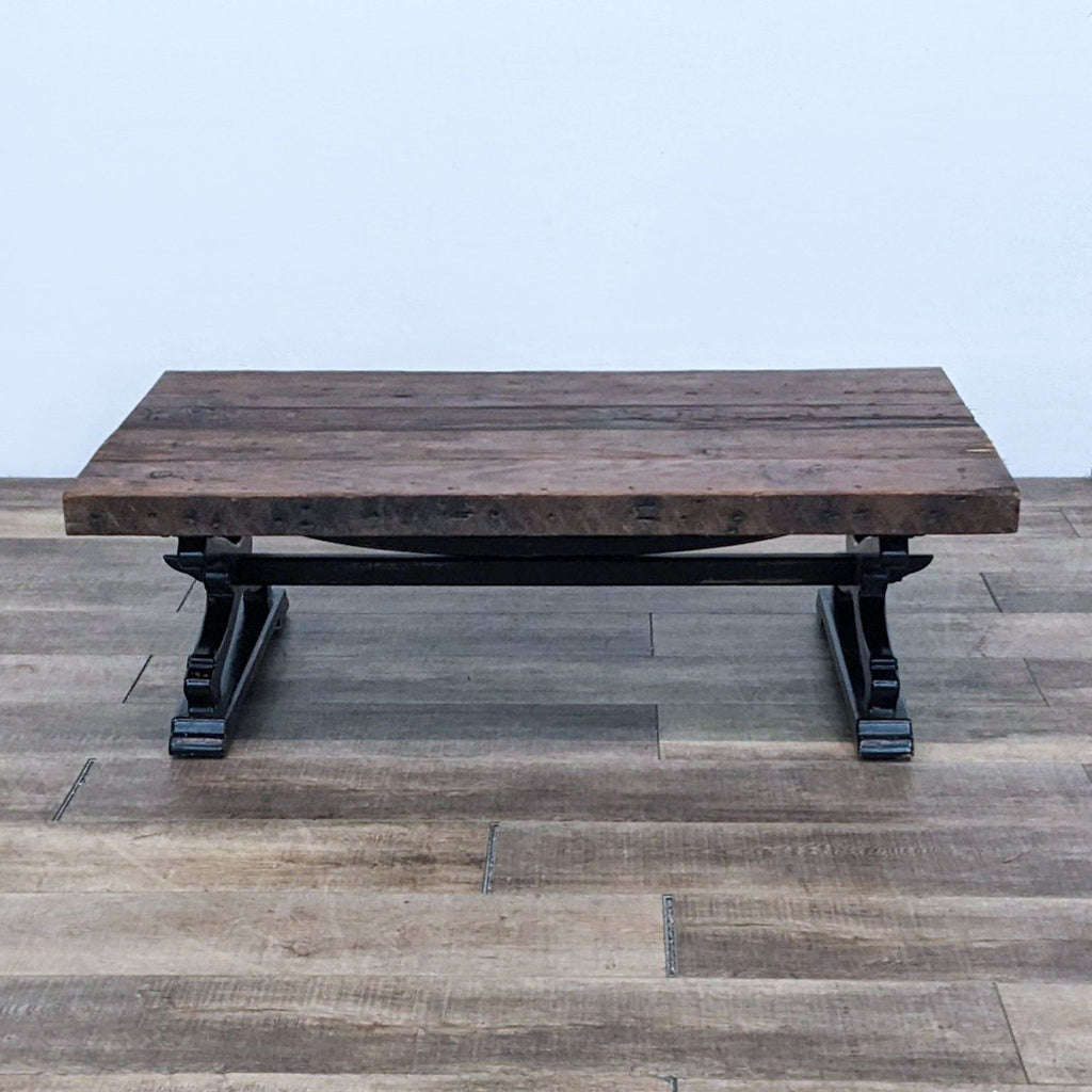 Reperch coffee table with a rustic wooden top and black metal legs.