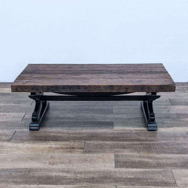 Reperch coffee table with a rustic wooden top and black metal legs.