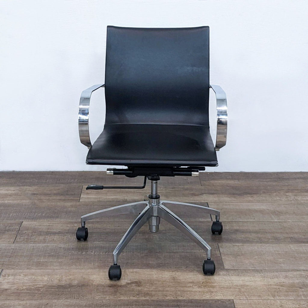 Front view of a black office chair with chrome arms and a metal star base.