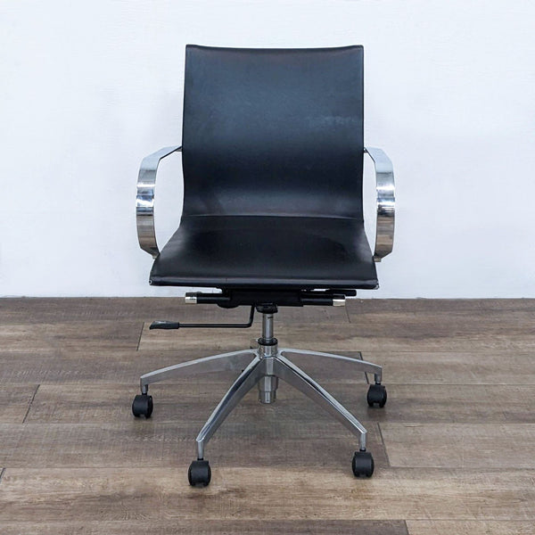 Front view of a black office chair with chrome arms and a metal star base.