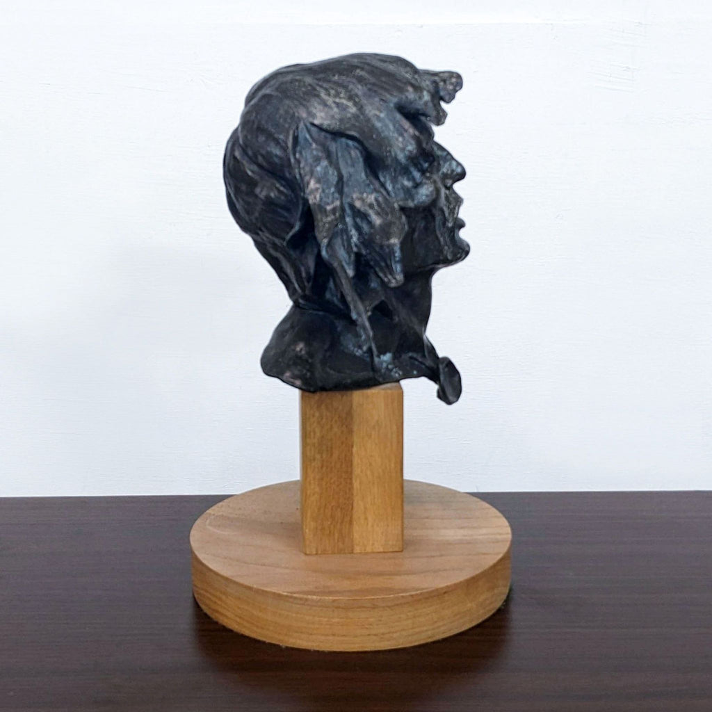 Side profile of "The Vision" bronze sculpture by Ron Herron on display.