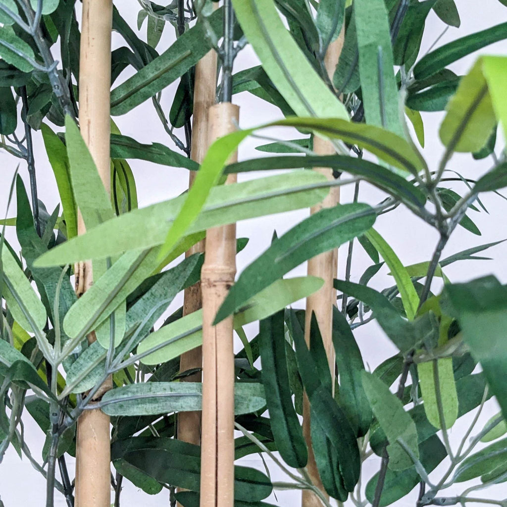 2. Close-up of a Reperch faux bamboo's leaves and stalks, showing realistic details in artificial greenery.