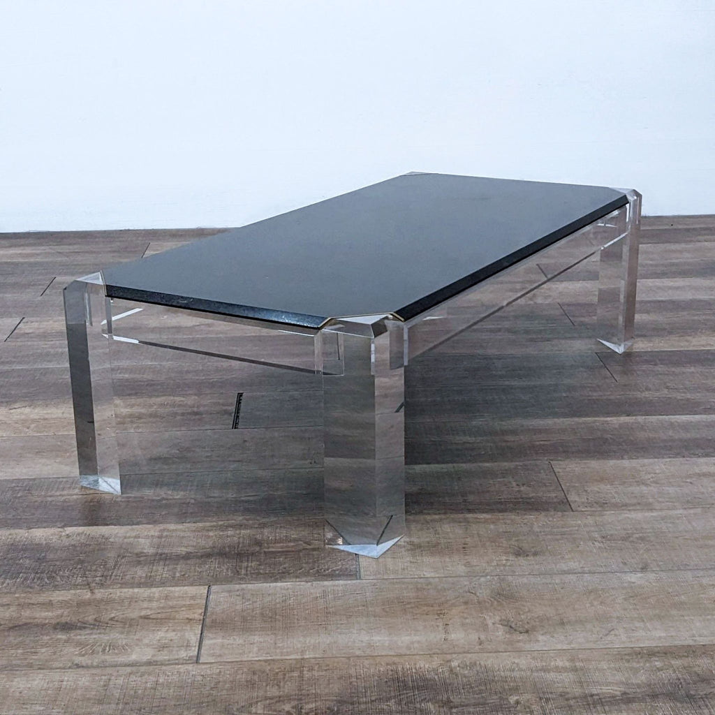 Side view of a stylish Reperch coffee table with clear acrylic legs.