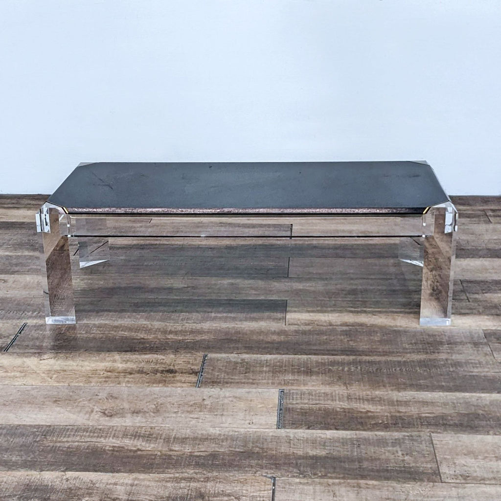A sleek black coffee table by Reperch on wooden flooring. 