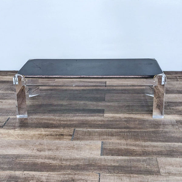 A sleek black coffee table by Reperch on wooden flooring. 