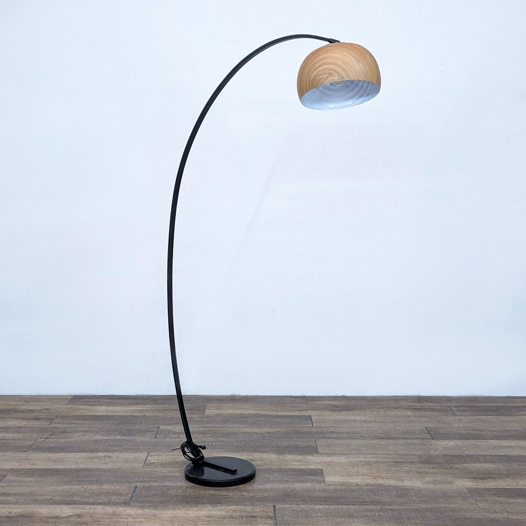 Arc floor lamp with faux woodgrain shade and perforated top, provides diffused upward light.