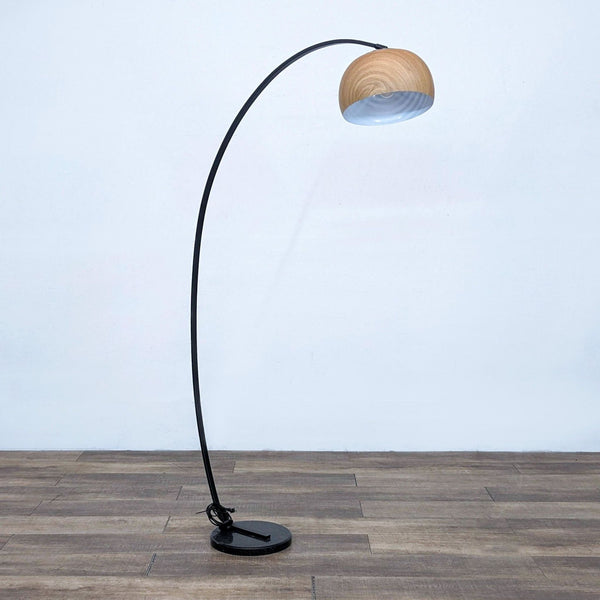 Arc floor lamp with faux woodgrain shade and perforated top, provides diffused upward light.