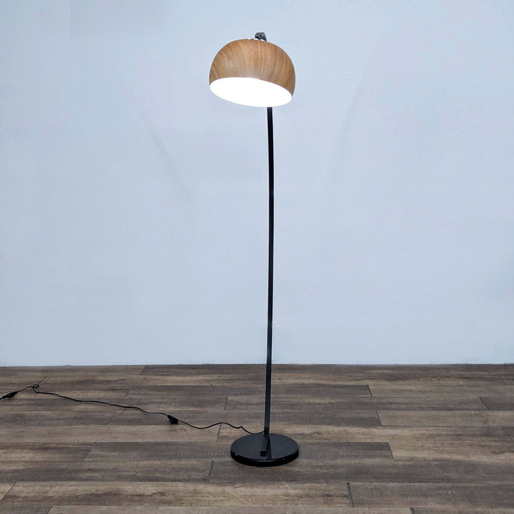 Zuo Modern's elegant arc lamp with a substantial base and distinctive faux woodgrain shade.