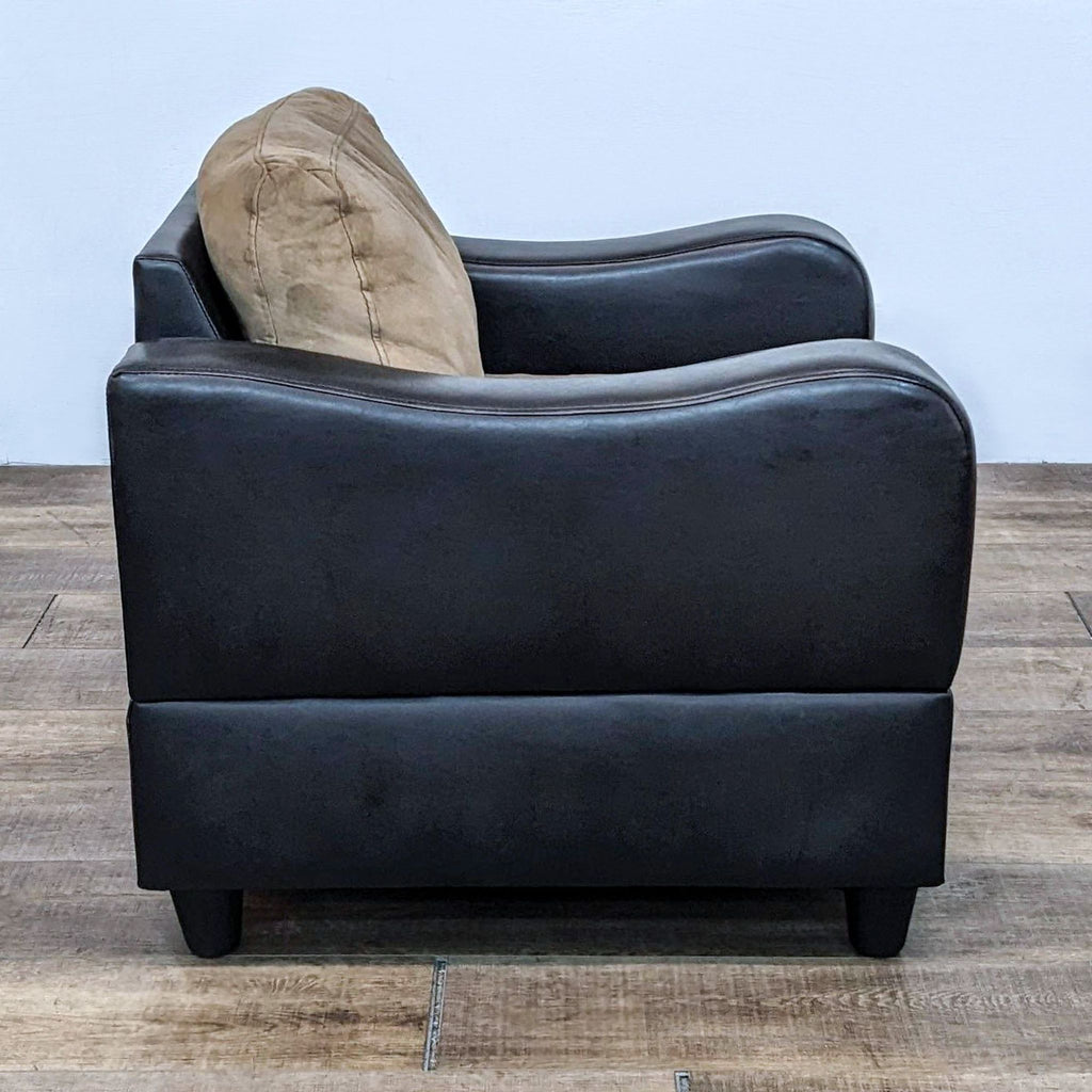 Side view of a modern faux leather lounge chair with cushioned seat, brand Reperch.