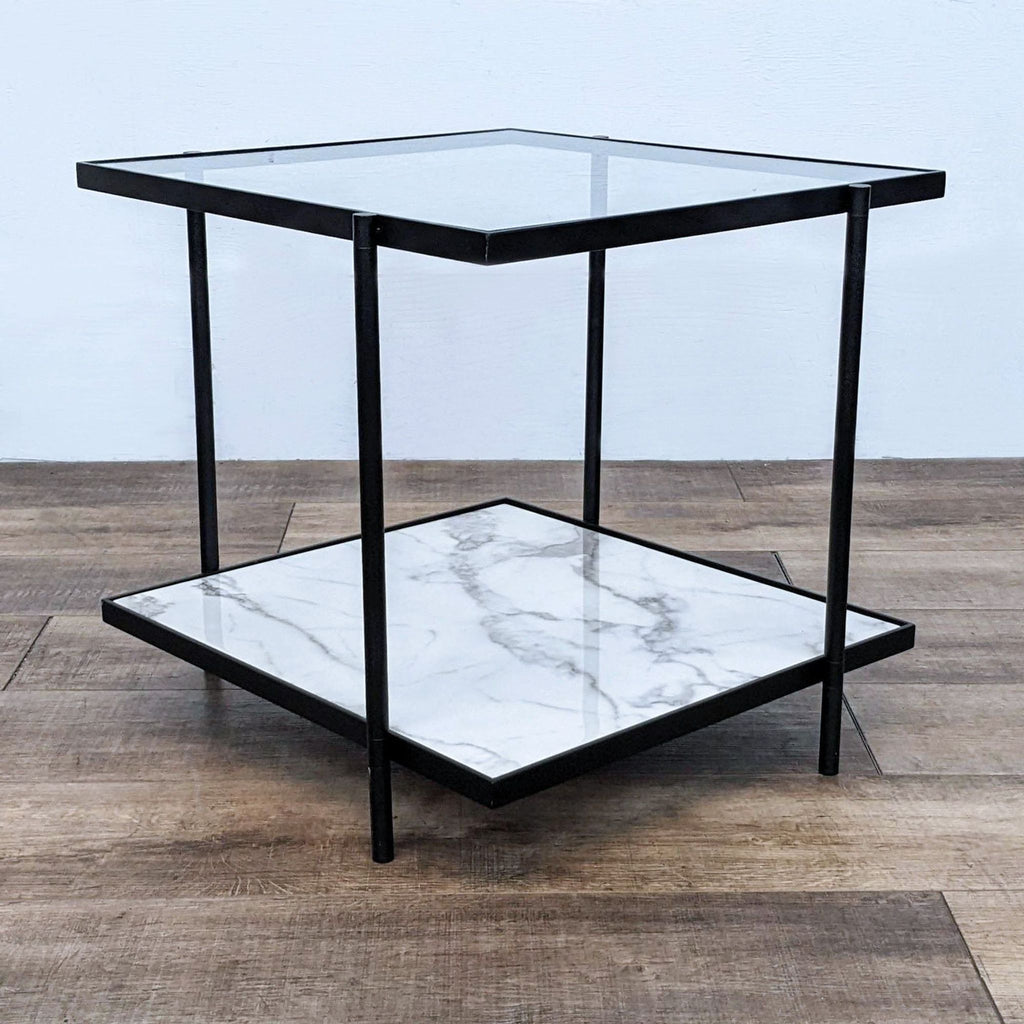Metal end table with a glass top and faux marble shelf on a wooden floor.