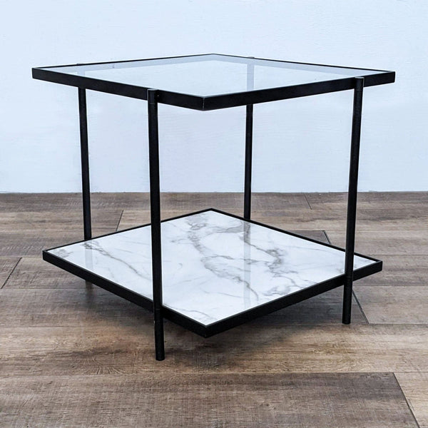 Metal end table with a glass top and faux marble shelf on a wooden floor.