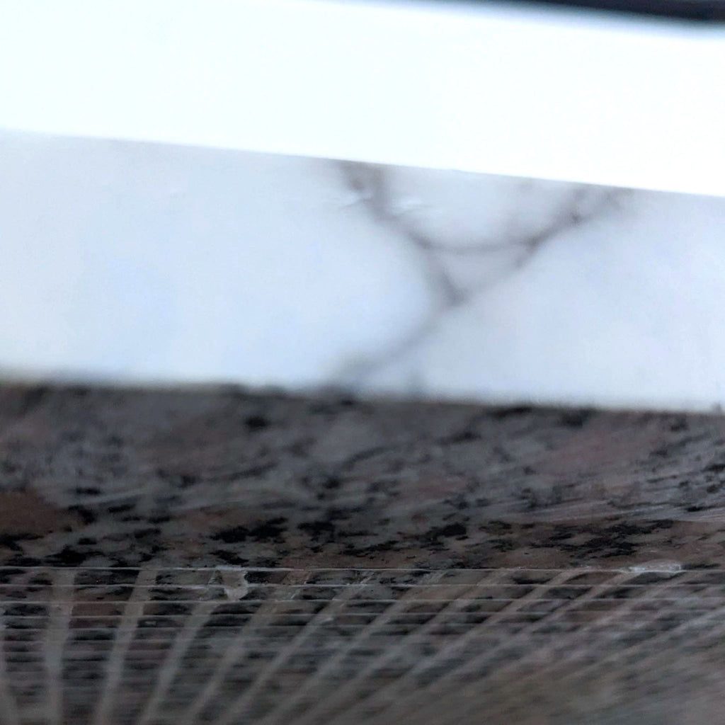 Close-up of the faux marble shelf detail on a metal end table.
