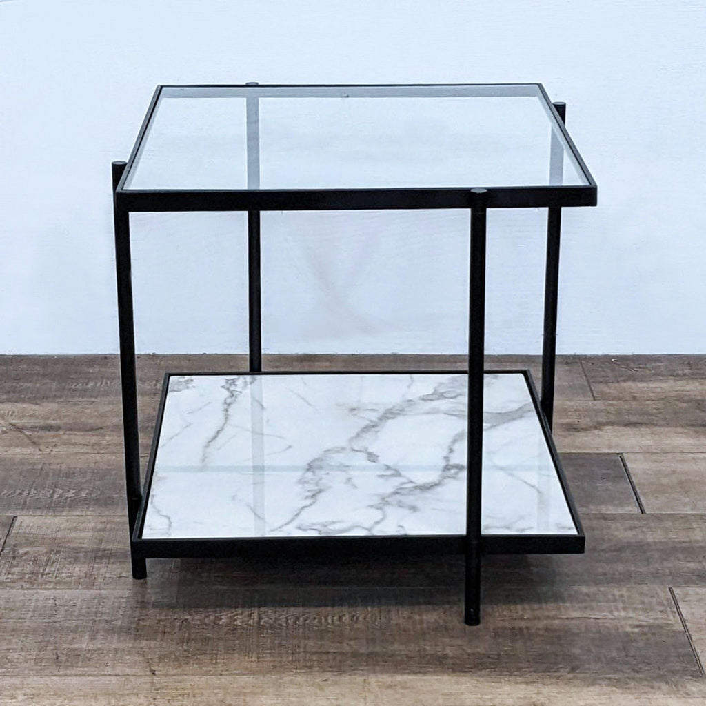 Square end table with black frame, glass surface, and marble-patterned lower shelf.