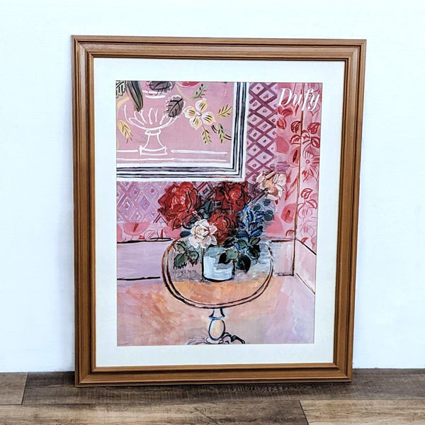 Framed Raoul Dufy print featuring vibrant flowers in a vase with a pink background.