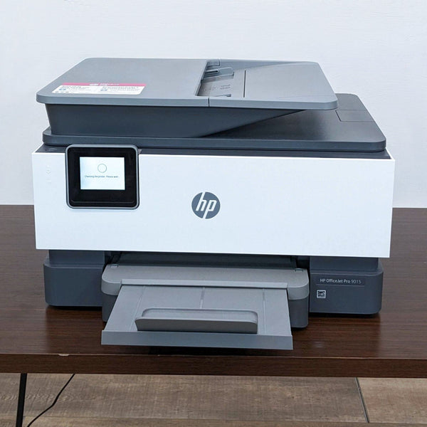 HP printer with closed scanner lid and display screen.  