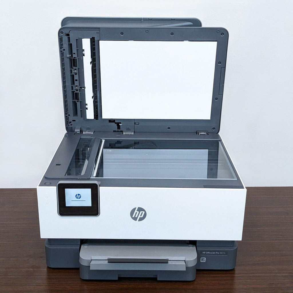 HP printer with open scanner lid, showing glass scanning bed.  