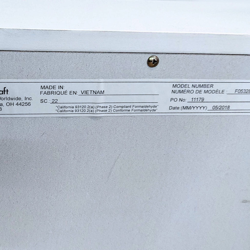 Close-up of a label on the end table detailing manufacturing information and compliance.