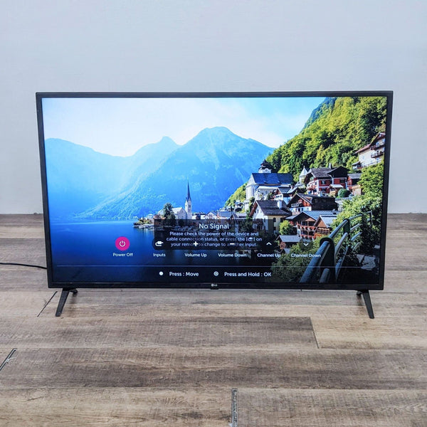 Front view of LG TV displaying a scenic landscape and a "No Signal" message.