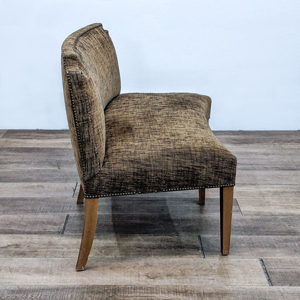 Curved olive green fabric bench, featuring nail head detailing and wooden finish legs.