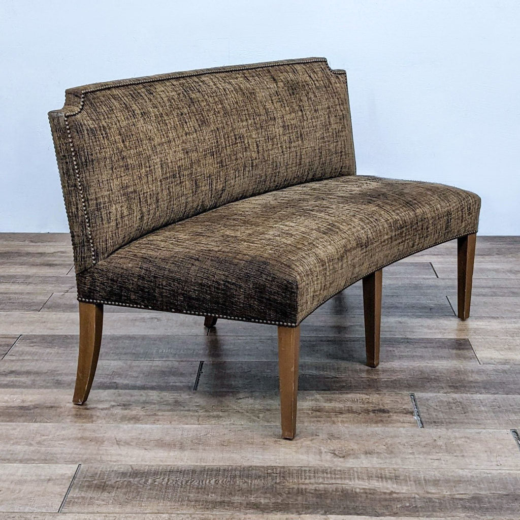 Bench with olive green upholstery, curved tight back, nail head accents, and wood-finished legs.