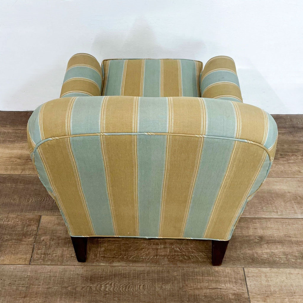 Back view of striped armchair, showcasing tapered wood feet.