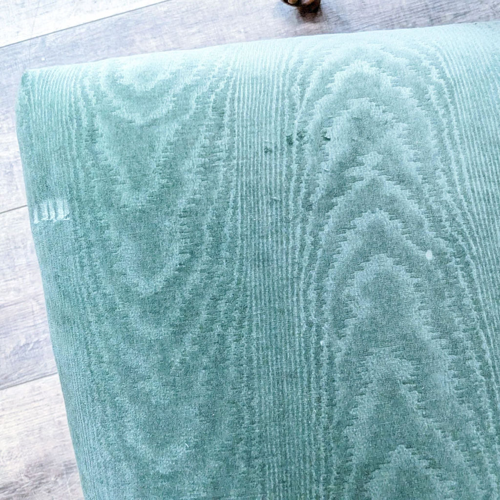 Detailed top view of a green upholstered chair from the Reperch dining set.